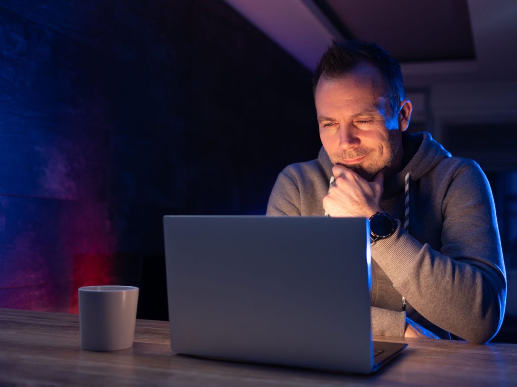 man on his laptop reviewing health benefits