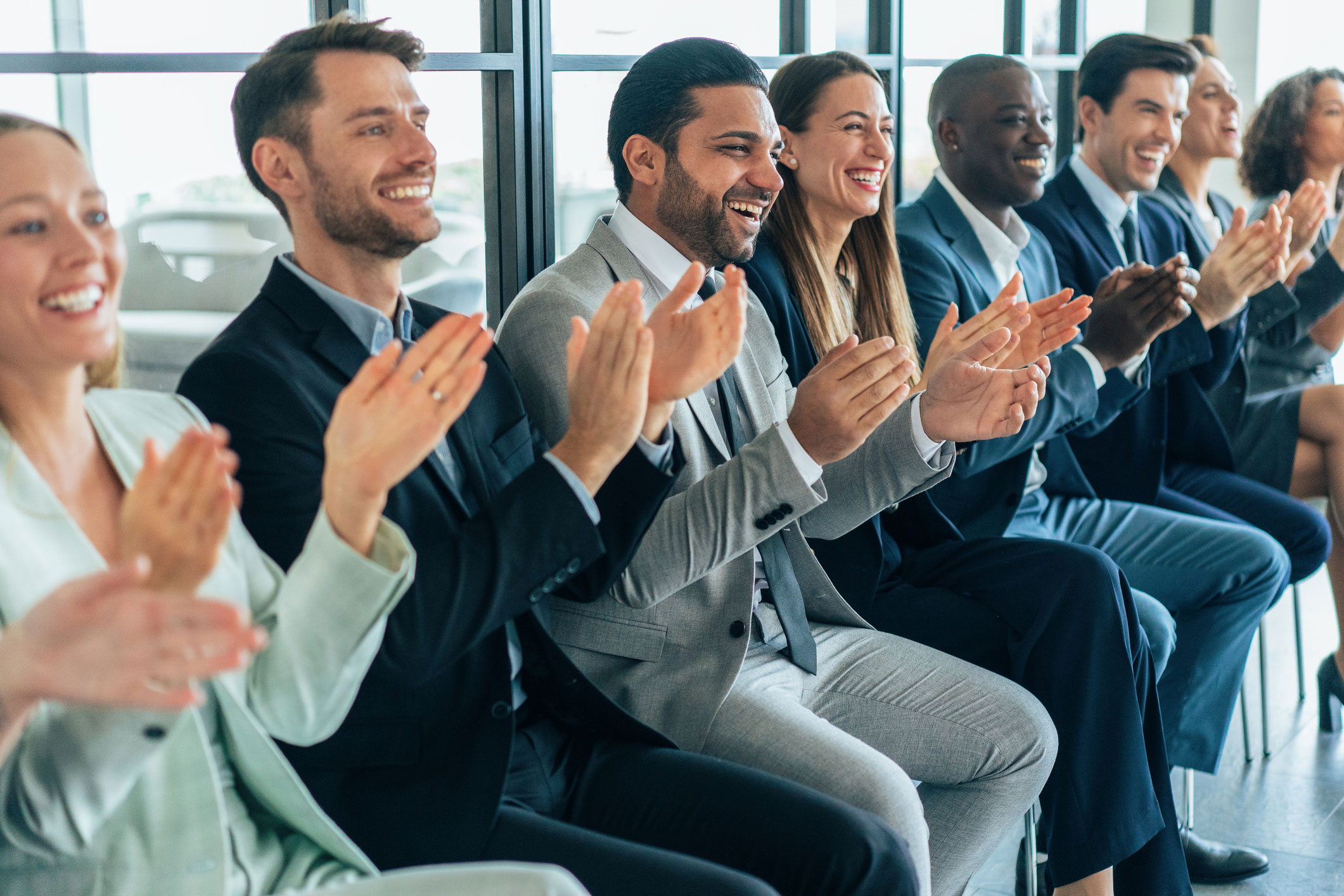business professionals clapping at an event