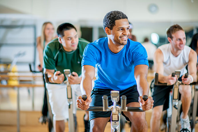 group of people in the middle of a cycling class