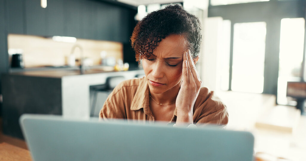 Woman, headache and stress in home for deadline, mistake or glitch as software malfunction.